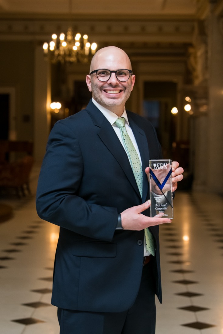 Michael Cannetti holding the FDU Alumni Volunteer of the Year award